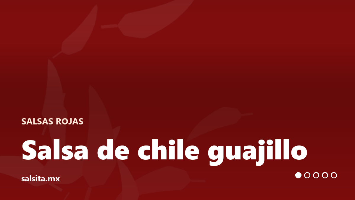 Deep red guajillo salsa in a bowl with a spoon